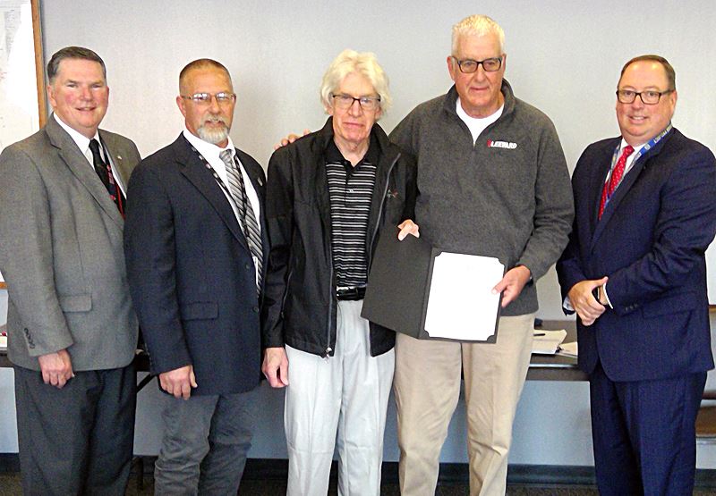  Roland Grote (center) and Eric Linde accept the proclamation declaring June as Parkinson’s Disease 