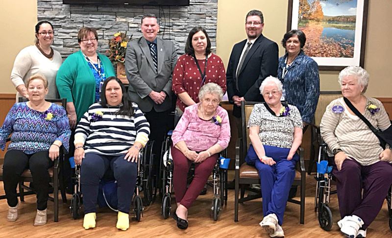 Senior residents at the Julia Ribaudo Extended Care Center pose with county and state officials afte