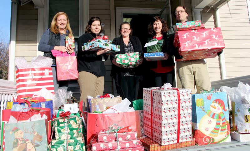 Staff members at Wayne Aging Office accepts wrapped Christmas gifts for 30 seniors in need.