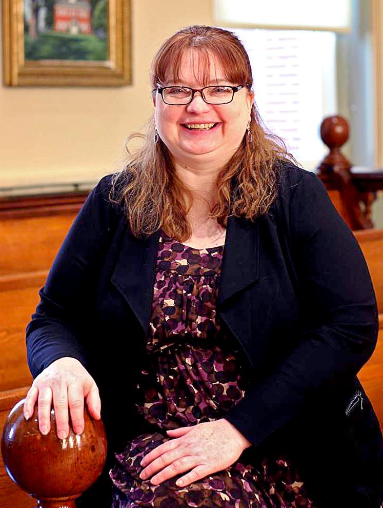 First Assistant DA Shelley Robison perches on a railing in the Historic Wayne County courtroom.